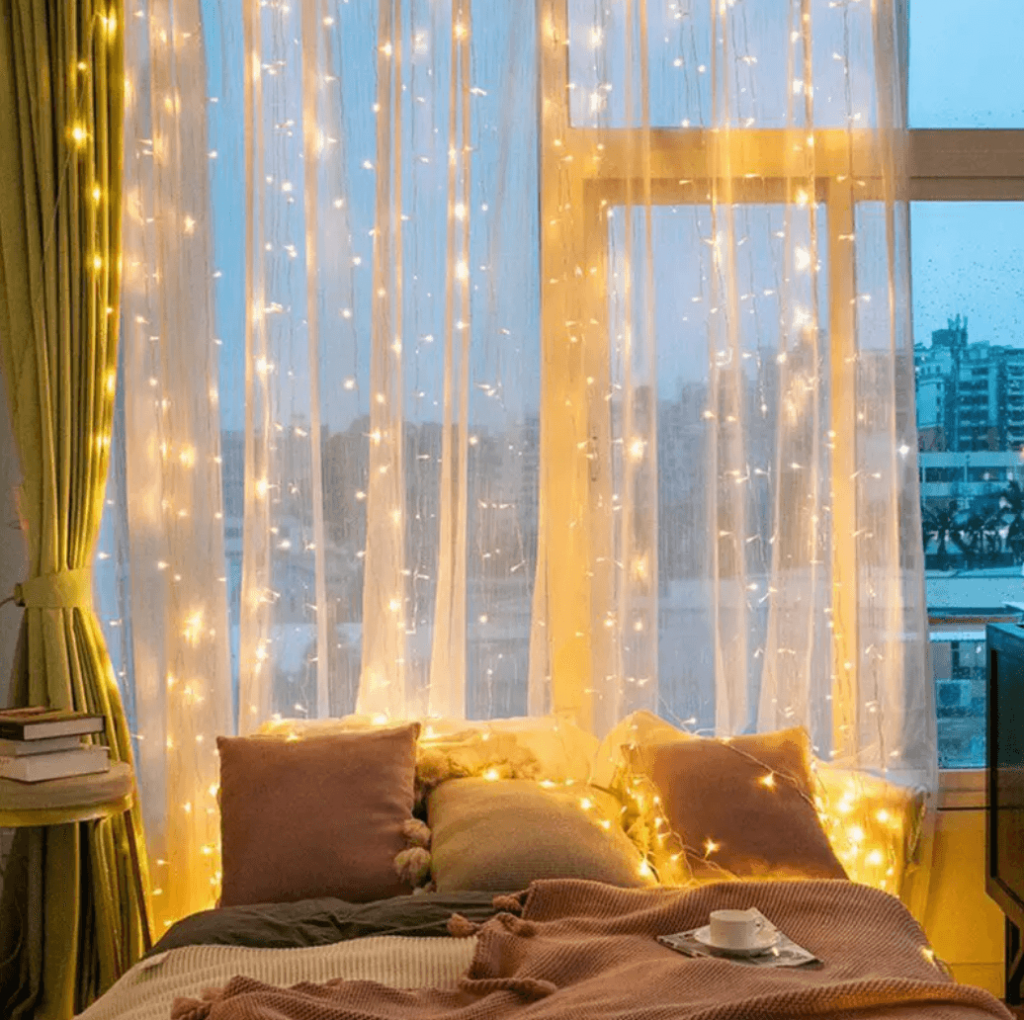 aesthetic curtain string lights behind bed