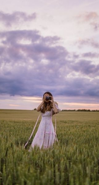 girl with camera pastel sky