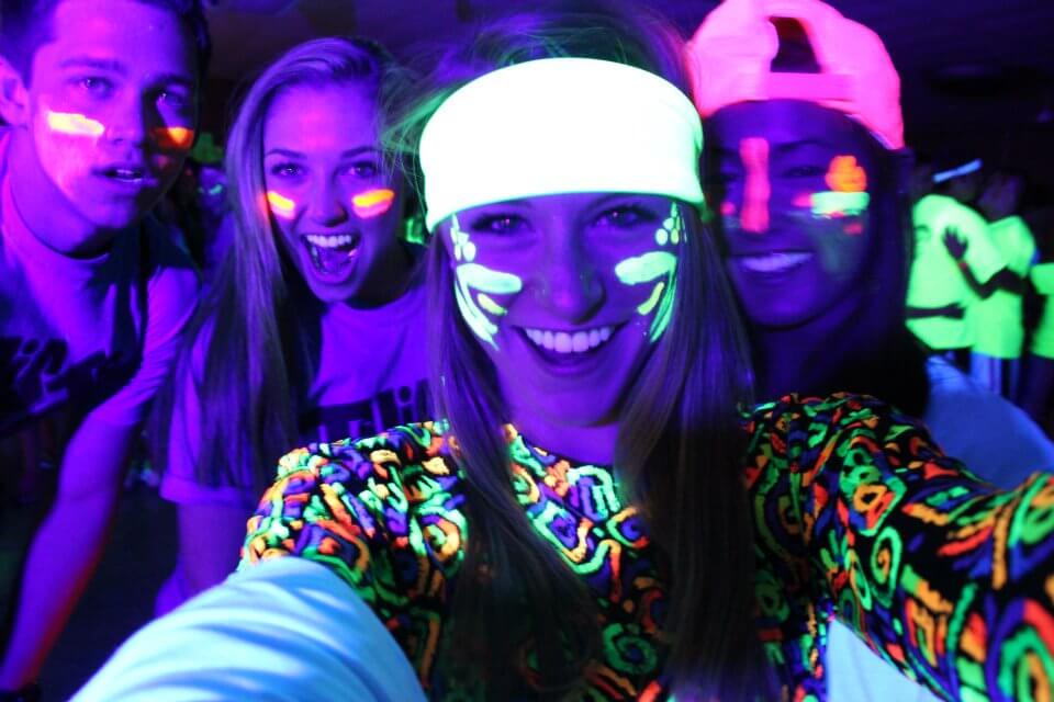 girls wearing glow in the dark face paint