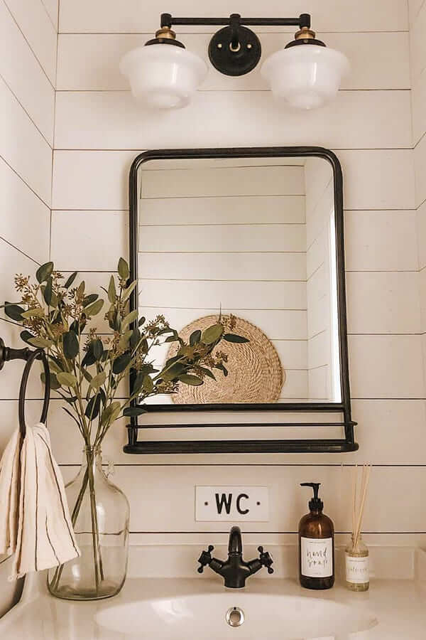 small bathroom counter decor with metal mirror