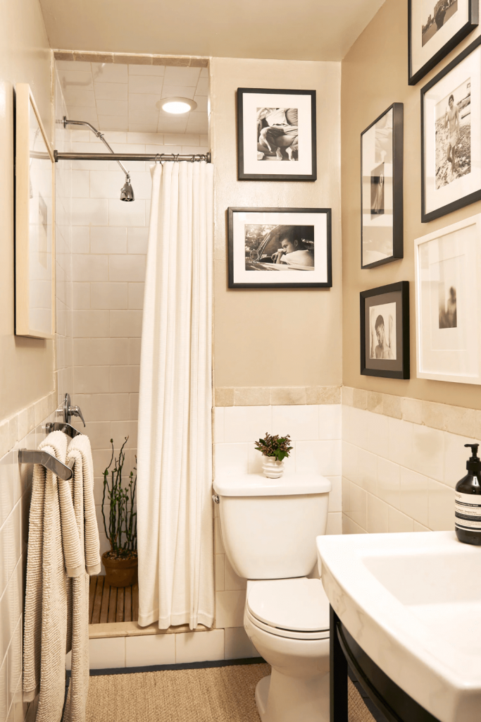small bathroom with photo gallery wall