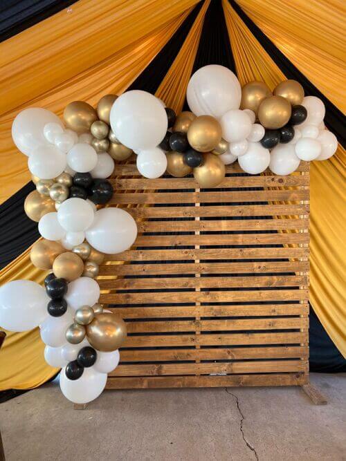 white gold and black balloon decor